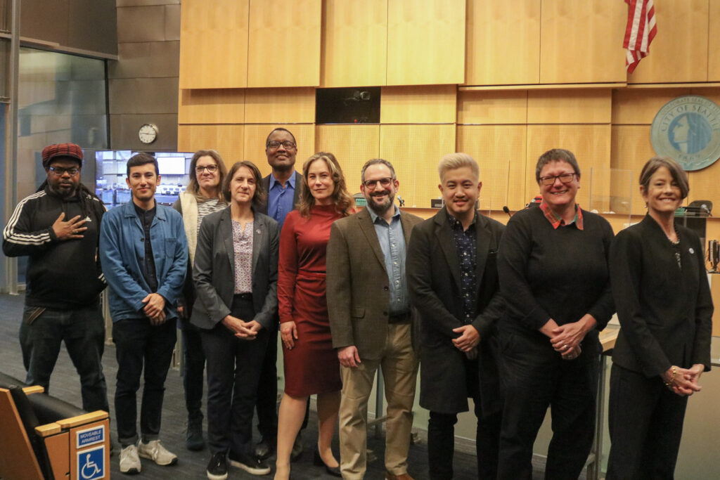Councilmember Sara Nelson stands with the first members of the Seattle Film Commission in Council Chambers.