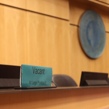 Seattle City Council name plate in Council Chambers reads "vacant."
