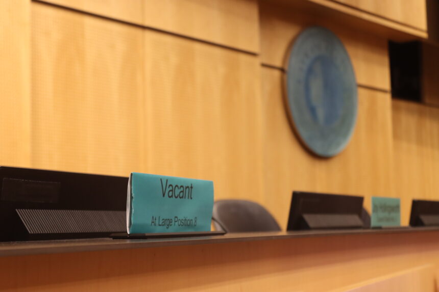 Seattle City Council name plate in Council Chambers reads "vacant."