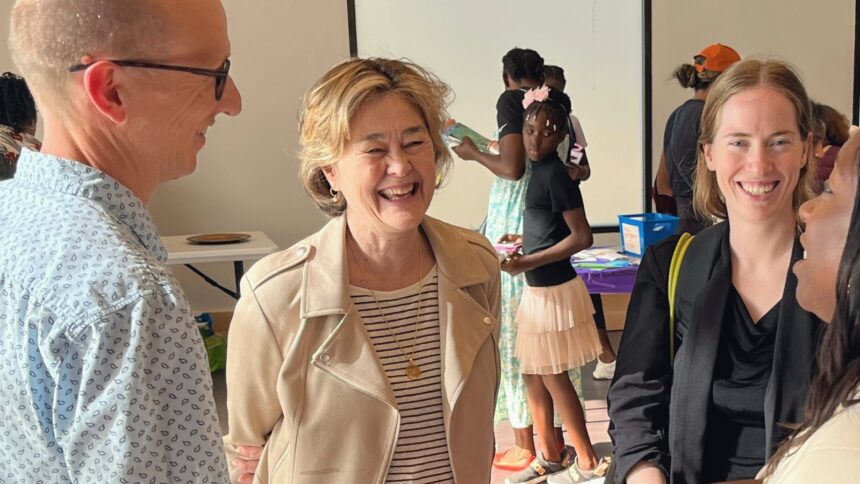 Councilmember Moore smiling while conversing with constituents