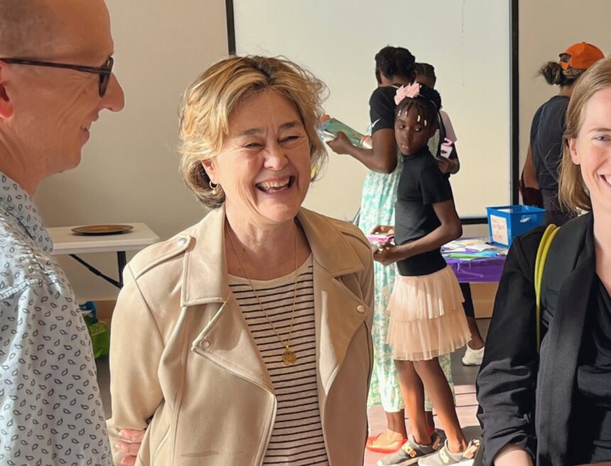 Councilmember Moore smiling while conversing with constituents