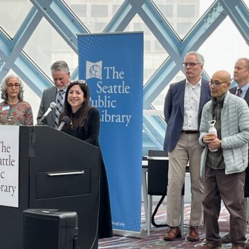 Councilmember Rivera speaking at a podium in Seattle Public Library Central Branch