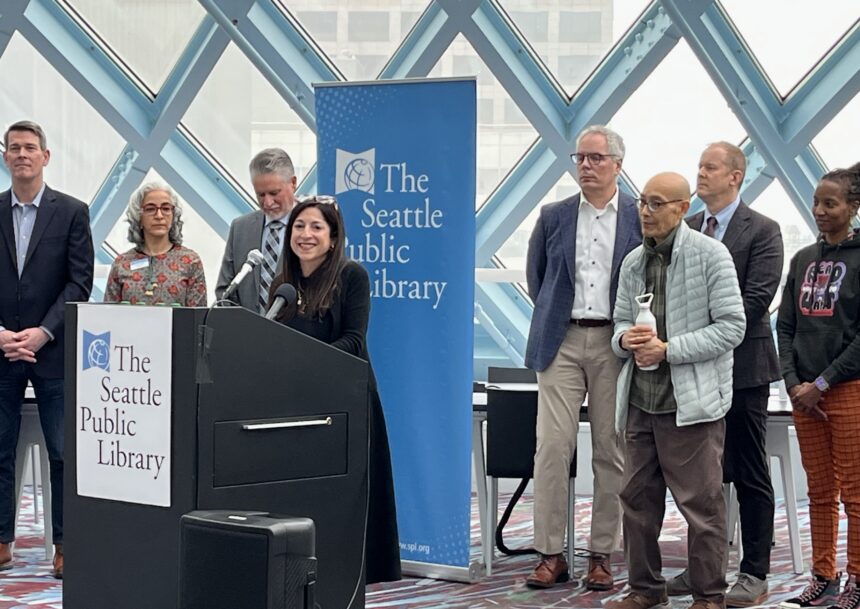 Councilmember Rivera speaking at a podium in Seattle Public Library Central Branch