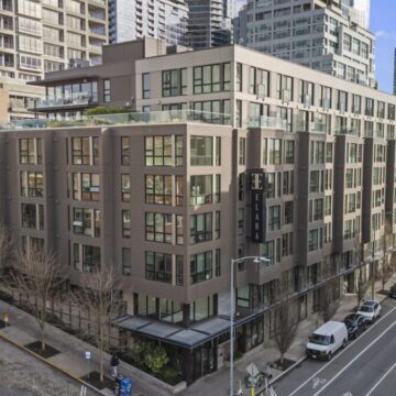 building on a corner with a sign that reads "Elara"