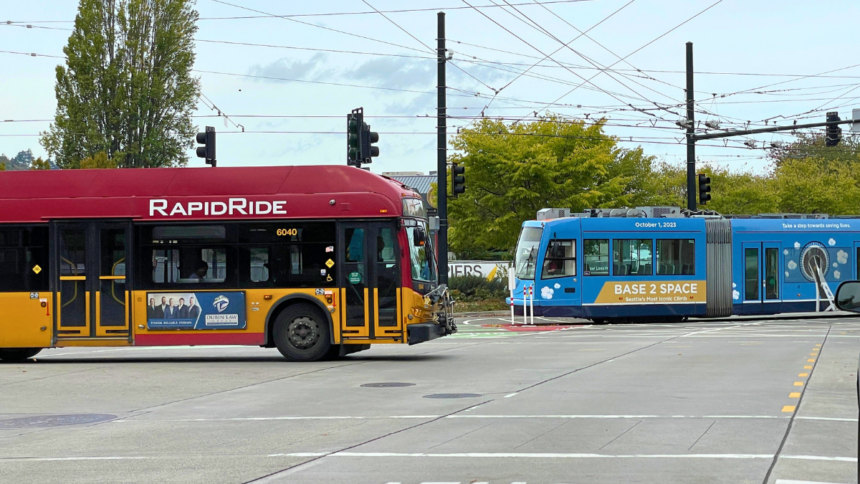 A Red bus and a blue streetcar moving in opposite directions