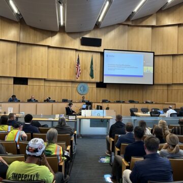 Seattle City Council Chambers filled with people, many in safety vests