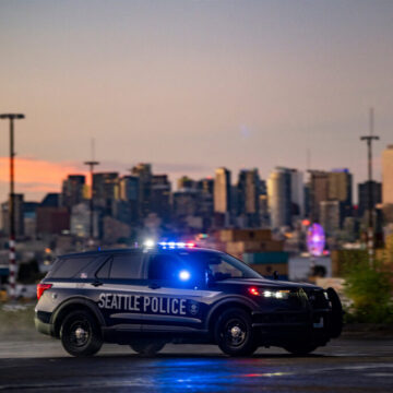 Seattle Police squad car with the Seattle skyline in the background at sunset