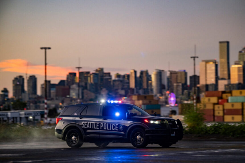 Seattle Police squad car with the Seattle skyline in the background at sunset