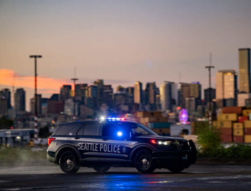 Seattle Police squad car with the Seattle skyline in the background at sunset